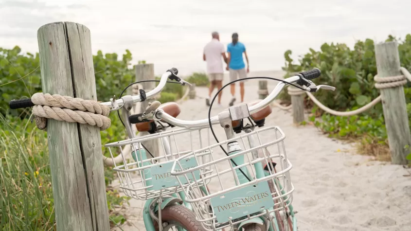 Couple walking to the beach holding each other