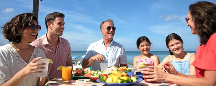 Family at beach eating food
